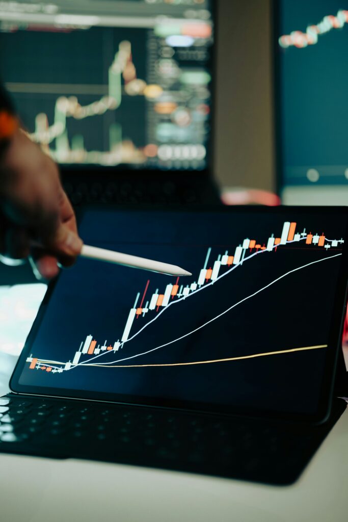 Business analytics dashboard showing upward revenue growth trend on tablet screen with stylus