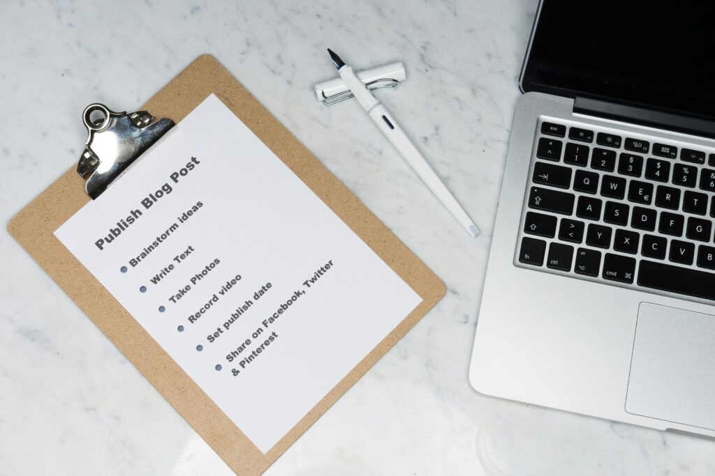 Systems audit checklist and business documentation spread on wooden desk for comprehensive review